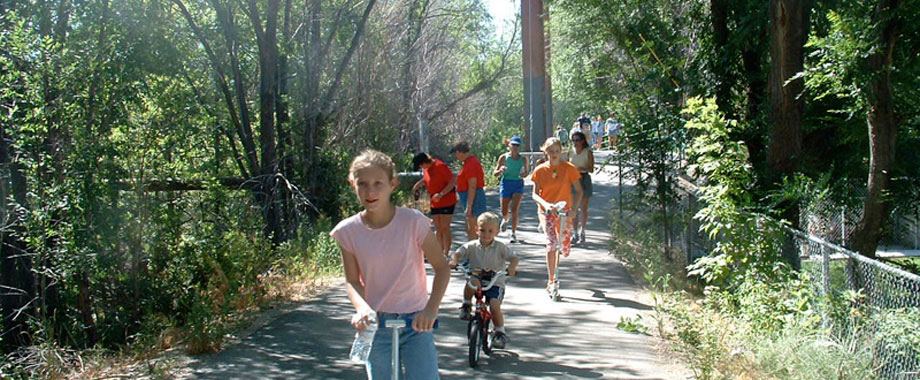 image: bikers and walkers on paved path